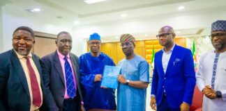 Dr. Iziaq Adekunle Salako Honourable Minister of State for Health & Social Welfare holding and displaying the signed MoU document with the Executive Governor of Edo State Senator Monday Okpebolo. 2nd Left: Barrister Tobi Omosa, Director, Legal Service Department in the Federal Ministry of Health & Social Welfare.