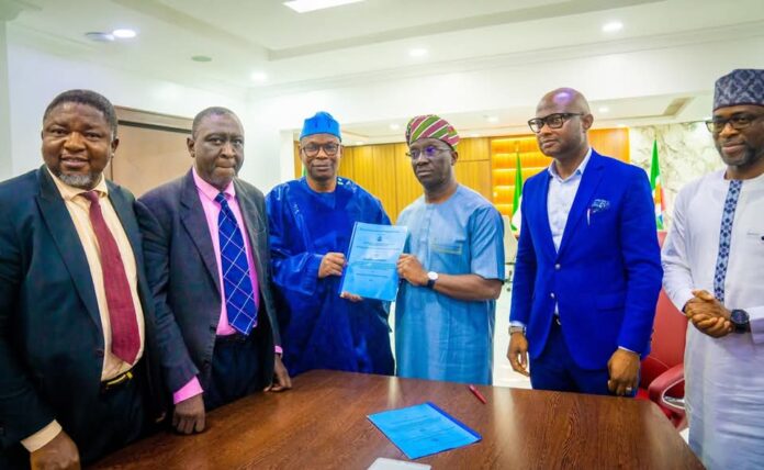 Dr. Iziaq Adekunle Salako Honourable Minister of State for Health & Social Welfare holding and displaying the signed MoU document with the Executive Governor of Edo State Senator Monday Okpebolo. 2nd Left: Barrister Tobi Omosa, Director, Legal Service Department in the Federal Ministry of Health & Social Welfare.