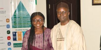 Newly-appointed Permanent Secretary, Labour and Employment, Dr. Salihu A. Usman (right) receiving handover notes from Director, Occupational Safety and Health, Lauretta Adogu, Abuja