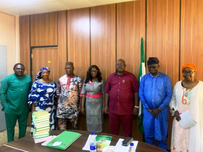 4th from left, Acting Secretary, NNMA, Mrs. Mercy Maltida Musa Moro'a, 3rd from right Dr. Onwusoro Maduka Ihemelandu, PS - FMSDIGA and 1st from right Director ( Parastatals) FMSDIGA in a group photograph with the NNMA Management Team.