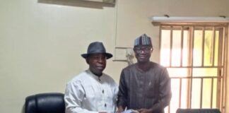 Incoming Permanent Secretary, Ndiomu Ebiogeh Phillip (Left) receiving hand-over documents from Mr. Ede Ogaba- Ag. Perm. Sec. and Director (Recruitment and Appointment).