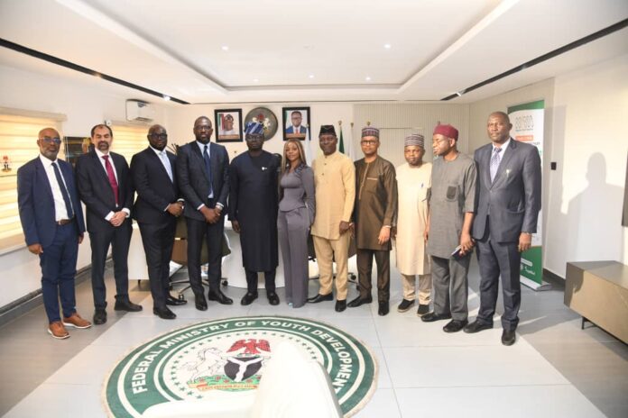 The Honourable Minister, Federal Ministry of Youth Development, Comrade Ayodele Olawande poses for a group photograph with management staff and representatives from Flutterwave and Alami Capital Management Group Limited during the signing of the Memorandum of Understanding (MoU).