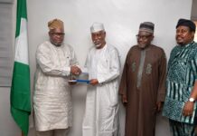 L-R : In a handshake , Surveyor General of the Federation Surv. Abudulganiyu Adeyemi Adebomehin receives the copy of the committee report from the Committee Chairman and Ex Minister of Environment, Surv. Suleiman Hassan Zarma next to him is a member of the committee Surv Umar Nasir and the Registrar of SURCON, Sur. Olugbemiro Olakunle