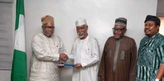 L-R : In a handshake , Surveyor General of the Federation Surv. Abudulganiyu Adeyemi Adebomehin receives the copy of the committee report from the Committee Chairman and Ex Minister of Environment, Surv. Suleiman Hassan Zarma next to him is a member of the committee Surv Umar Nasir and the Registrar of SURCON, Sur. Olugbemiro Olakunle