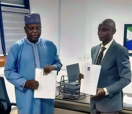 R-L the outgoing Permanent Secretary Adeleye Adeoye holding the handover notes while the Acting Permanent Secretary/Director, Road Transport and Mass Transit Administration Musa Ibrahim holds a copy of the handover notes. He takes over the mantle to oversee the office of the Permanent Secretary, pending the deployment of a substantive Permanent Secretary.