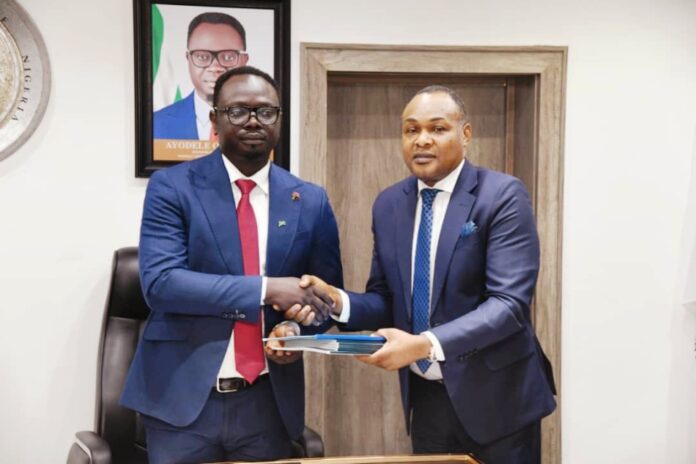 L-R; Hon. Minister of Youth Development , Comrade Ayodele Olawande receiving Report of Technical Committee on the Establishment of National Youth Development Bank (NYDB) From the Committee Co-Chairman, Mr. Bonaventure Okhaimo, today March 24. 2025.