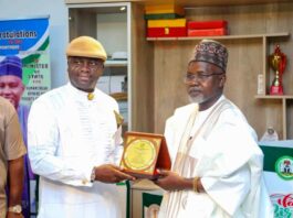 Right, Honourable Minister of State Federal Ministry of Humanitarian Affairs and Poverty Reduction, Dr Yusuf Tanko Sununu, Danmadamin Yauri receiving a Plaque of Honour in recognition of his contributions to humanity and National Development from the National Chairman, Niger Delta People Salvation Front (NDPSF) Alabo Engr Obomate Harry, during a working visit by the group to the Minister of State on Friday 28th February 2025 Federal Secretariat Abuja