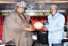 FCSC Chairman, Prof. Tunji Olaopa (Left) presented with a plaque by Registrar of JAMB; Prof. Ishaq Oloyede at the event.