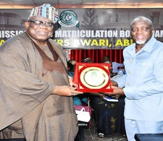 FCSC Chairman, Prof. Tunji Olaopa (Left) presented with a plaque by Registrar of JAMB; Prof. Ishaq Oloyede at the event.
