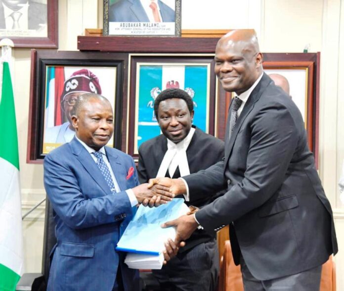 The Honourable Attorney-General of the Federation and Minister of Justice, Prince Lateef Fagbemi SAN, receiving the Report from the Facilitator of the Working Group on the Legal Status of Inmates in Correctional Centres, Olawale Fapohunda (SAN) on Wednesday 19th March, 2025 in Abuja.