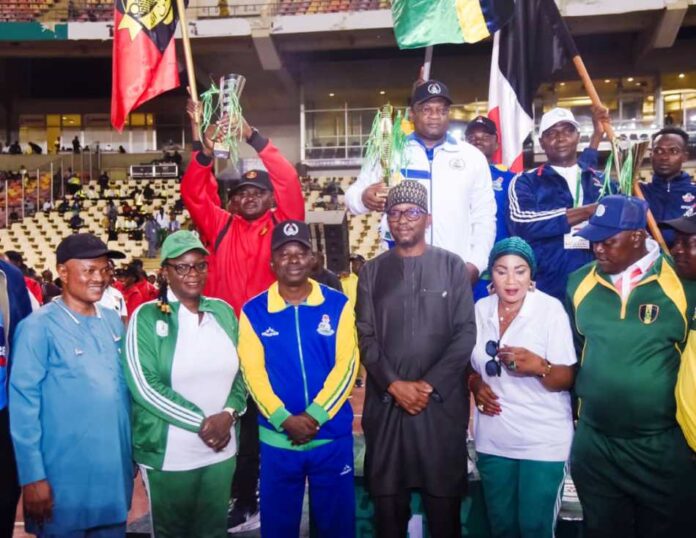 6th Osom Games Chairman, National Sports Commission, Mallam Shehu Dikko flanked to his left by Director, Grassroots Sport, Mrs. Amaka Ashiofu, Ahmed Kawu SA to the Chairman, to his Right, Representative of Nigeria Police Force, Brig. Gen. Ektuk of Nigeria Army, Mrs. Kehinde Ajayi, Director Press and Public Relations (NSC) and some medalists during the closing ceremony of One Service One Medal Gamees at the MKO Abiola National Stadium, Abuja on Tuesday 29th April, 2025.