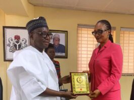 RMAFC Chairman, Dr. Mohammed Bello Shehu OFR, presenting a memorabilia to the visiting Director General of ALGON, Barr. Evan Enekwe at RMAFC HQ, Abuja.