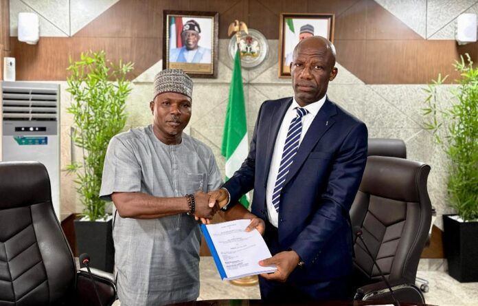 Mr Ogbodo Chinasa Nnam and Mr Ibidapo Okunnu Mr Ogbodo Chinasa Nnam, Permanent Secretary, Federal Ministry of Information and National Orientation (left) receiving hand over documents from Mr Ibidapo Okunnu (right) who oversaw the office, on Monday May 12 2025.