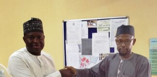 The representative of the Acting Executive Director, NIWRMC, Engineer Shazali Uba Ajingi presenting the Water Use Licence to the Head of Agronomy and Government Relations, Olam Nigeria Ltd, Dr. Umaru Ismaila in his office in Abuja