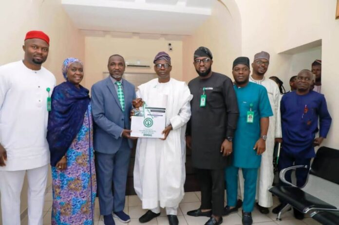 Nigeria’s Healthcare System Group Picture with Dr. Iziaq Adekunle Salako Honourable Minister of State for Health & Social Welfare (Middle) by the NMA officials: with Dr. Bala Audu President Nigeria Medical Association NMA presenting a souvenir to the HMS.