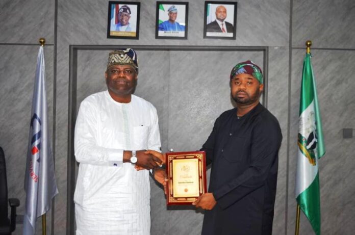 RMAFC Synergises With FIRS From left: Hon. Kolade Daniel Abimbola receiving a memorabilia from the FIRS Chairman Dr. Zacch Adedeji.