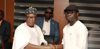 The Honourable Minister of Youth Development, Comrade Ayodele Olawande, receives the official handover document from his counterpart, the Honourable Minister of Regional Development, Engr. Abubakar Momoh, during a formal ceremony marking the transfer of the Agadagba Skill Acquisition Centre.