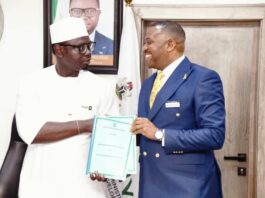 L-R The Honourable Minister, Comrade Ayodele Olawande, and the representative of Investonaire Academy, Dr. Enefola Odiba, at the signing ceremony of the MoU to train Nigerian youth in Forex trading.