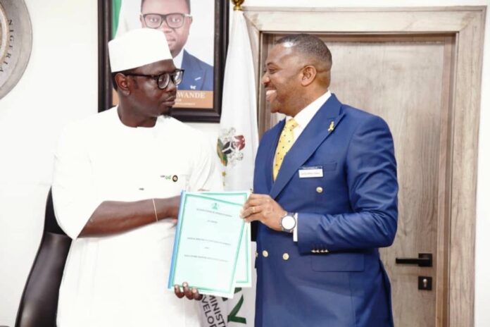 Comrade Ayodele Olawande, and Dr. Enefola Odiba L-R The Honourable Minister, Comrade Ayodele Olawande, and the representative of Investonaire Academy, Dr. Enefola Odiba, at the signing ceremony of the MoU to train Nigerian youth in Forex trading.