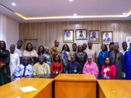 The Permanent Secretary of the Ministry of Communication Innovation and Digital Economy Mr Adeladan Rafiu Olarinre in a group photograph with the Head of Service of the Federation with other Dignitaries on a field visit on the ECM implementation today 23rd June, 2025 at the Permanent Secretary's conference room 6th floor, Federal Secretariat Abuja.