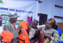 Director, Maritime Services Department, Dr. Mercy Ilori presents the life jacket to the Secretary to the Government, Kwara State, Prof. Mamman Saba Jibril.