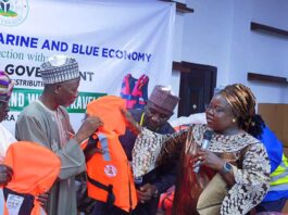 Director, Maritime Services Department, Dr. Mercy Ilori presents the life jacket to the Secretary to the Government, Kwara State, Prof. Mamman Saba Jibril.
