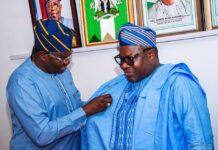 Director General and Chief Executive of the National Space Research and Development Agency Dr. Matthew Adepoju decorating Surveyor General of the Federation Surv. Abudulganiyu Adeyemi Adebomehin with his organisation symbolic lapel pin
