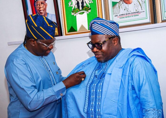 SGOF Pledges To Support NASRDA Director General and Chief Executive of the National Space Research and Development Agency Dr. Matthew Adepoju decorating Surveyor General of the Federation Surv. Abudulganiyu Adeyemi Adebomehin with his organisation symbolic lapel pin