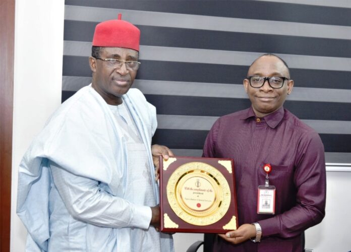 BPP Partners with NIQS Right: Director-General, Bureau of Public Procurement (BPP) Dr. Adebowale A. Adedokun, FCIPS, ACFE, receiving a plaque from the President, Nigerian Institute of Quantity Surveyors (NIQS), Qs, Kene Nzekwe, FNIQS, during his visit to BPP office in Abuja