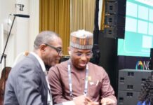 The Permanent Secretary MPR. Dr. Emeka Vitalis Obi mni (right) tutoring a visitor to the MPR's Exhibition Booth about the operationalisation of the Ministry's Scan Code at the 2025 NOG Energy Week in Abuja.