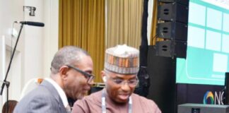 The Permanent Secretary MPR. Dr. Emeka Vitalis Obi mni (right) tutoring a visitor to the MPR's Exhibition Booth about the operationalisation of the Ministry's Scan Code at the 2025 NOG Energy Week in Abuja.