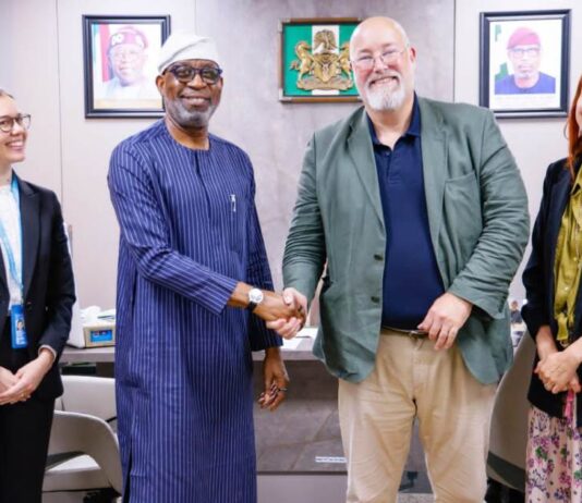 Minister of Solid Minerals Development, Dr. Dele Alake, in a warm handshake with Project Co-ordinator, United Nations Office of Drugs and Crime, Mr.Tom Parker. With them are project officers Nicole Anderson (left) and Inneke Geysens- Bourgions, ((right)