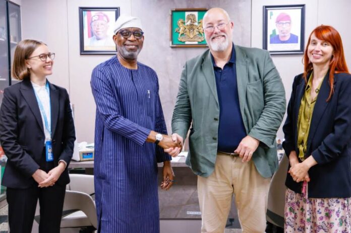 Minister of Solid Minerals Development, Dr. Dele Alake, in a warm handshake with Project Co-ordinator, United Nations Office of Drugs and Crime, Mr.Tom Parker. With them are project officers Nicole Anderson (left) and Inneke Geysens- Bourgions, ((right)