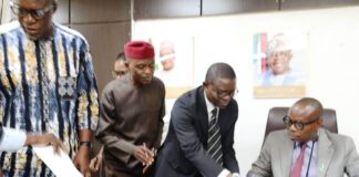 Honourable Minister of State for Health & Social Welfare Dr. Iziaq Adekunle Salako signing on behalf of the Ministry. Wearing red cap: Founder & Pro- Chancellor Achievers University Owo, Prof. Bode Ayorinde; 1st Left Dr. Hamed Liasu Medical Director Federal Medical Centre Owo- Ondo State. Wearing suite: The Director Legal Services Department of the FMoHSW, Barrister Okohagiam