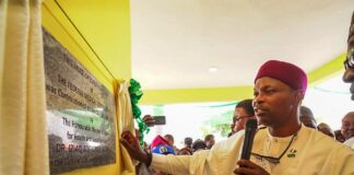 Dr. Iziaq Adekunle Salako Honourable Minister of State for Health & Social Welfare drawing the curtain on the plaque Commissioning the Multi-Specialty Complex of the Federal Medical Centre Keffi Nasarawa State.