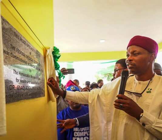 Dr. Iziaq Adekunle Salako Honourable Minister of State for Health & Social Welfare drawing the curtain on the plaque Commissioning the Multi-Specialty Complex of the Federal Medical Centre Keffi Nasarawa State.