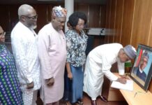 The Permanent Secretary, Ministry of Regional Development, Dr. Mary Ada Ogbe with top management staff look on as, the Honourable Minister, Ministry of Regional Development, Engr. Abubakar Momoh signing the Condolence Register of late former President Muhammadu Buhari, in his office on the 11th floors, Federal Secretariat Phase 1, Abuja.