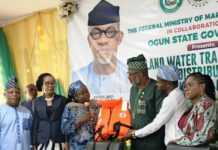 Director Maritime Services, Federal Ministry of Marine and Blue Economy, Dr. Mercy Ilori (l), presents the life jacket to the Ogun State Commissioner fir Transportation, Engr. Gbenga Dairo at Abeokuta.