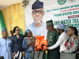 Director Maritime Services, Federal Ministry of Marine and Blue Economy, Dr. Mercy Ilori (l), presents the life jacket to the Ogun State Commissioner fir Transportation, Engr. Gbenga Dairo at Abeokuta.