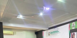 Pharmacist (Mrs)Olubunmi Aribeana reading the Keynote address of the Honourable Coordinating Minister of Health and Social Welfare Professor Muhammad Ali Pate at the Ministerial Press Briefing, marking the Maiden National Self-Care Day 2025.