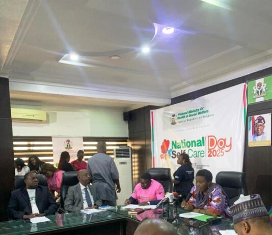 Pharmacist (Mrs)Olubunmi Aribeana reading the Keynote address of the Honourable Coordinating Minister of Health and Social Welfare Professor Muhammad Ali Pate at the Ministerial Press Briefing, marking the Maiden National Self-Care Day 2025.