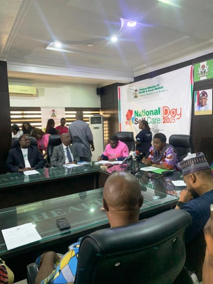 Pharmacist (Mrs)Olubunmi Aribeana reading the Keynote address of the Honourable Coordinating Minister of Health and Social Welfare Professor Muhammad Ali Pate at the Ministerial Press Briefing, marking the Maiden National Self-Care Day 2025.