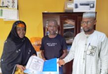 The Acting Executive Director, Nigeria Integrated Water Resources Management Commission (NIWRMC), Mrs. Sakinatu Suleiman Abbo Jimeta (L) making presentation of the Water Use Licence to Engr Leo Morga, Technical Manager, Nigeria Mills, Calabar, (M) flanked by the Director, Allocation and Authorisation, Engr Shazali Uba Ajingi (R) in Abuja.