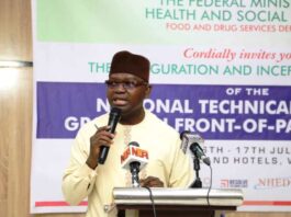 The Permanent Secretary Federal Ministry of Health & Social Welfare Daju Kachollom mni, represented by Dr. Dogara Okara Senior Technical Assistant to the Permanent Secretary, delivering the keynote address during the opening ceremony of the Inauguration & Inception of the National Technical Working Group on Front - of- Pack Labelling programme - organized by the Food & Drug Services Department of Federal Ministry of Health & Social Welfare.