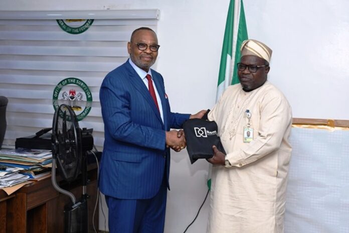 Osgof- Adebomehin Counsels Security Agents And The Military L-R : The former General Manager of Shell Group and the current Group Managing Director of the Nembe Exploration and Production Company Limited Ike Okoronkwo presenting his company gift to Surveyor General of the Federation (SGOF) Abduganiyu Adeyemi Adebomehin during his visit