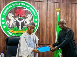 The Honourable Minister of Marine and Blue Economy, His Excellency Adegboyega Oyetola, CON (left) receiving a presentation from the Acting President, Fisheries Cooperative Federation of Nigeria (FCFN), Mr. Mashi Gabriel Sani, at an interactive session with fisheries cooperatives groups in Abuja on Wednesday.