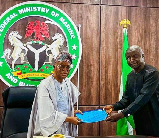 The Honourable Minister of Marine and Blue Economy, His Excellency Adegboyega Oyetola, CON (left) receiving a presentation from the Acting President, Fisheries Cooperative Federation of Nigeria (FCFN), Mr. Mashi Gabriel Sani, at an interactive session with fisheries cooperatives groups in Abuja on Wednesday.