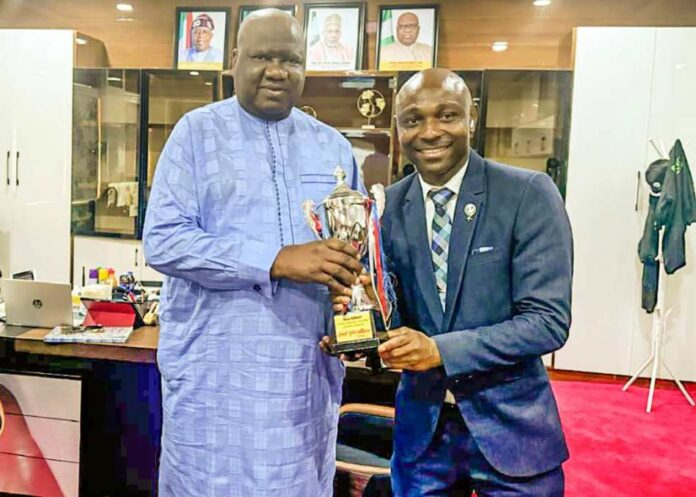 Team Humanitarian Presentation of the Trophy and Certificate of Merit won by Team Humanitarian as the Second Best KITTED at the July 2025 Edition of Keep fit Aerobics Exercise held at the Moshood Abiola National Stadium, Abuja. The presentation was made to the Permanent Secretary Federal Ministry of Humanitarian Affairs and Poverty Reduction, Dr Yakubu Adam Kofarmata, by the Director Humanitarian Resource Management of the Ministry, Onyia- Daisy CH, accompanied by the Sport Manager, kazeem Adenekan and other team members.