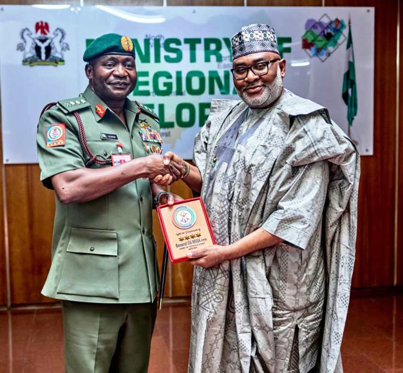 R-L : the Hon. Minister of State, Regional Development Uba Maigari Ahmadu receiving a plague from the Chief of Defence Staff, General Christopher Musa during a courtesy to Minister of State's office in Abuja.