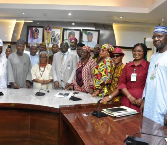 The Permanent Secretary of the Ministry, Dr Marcus Olaniyi Ogunbiyi (C), and members of the Committee during the Inauguration.